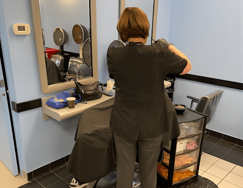 anne of contours hair design working on a client's hair